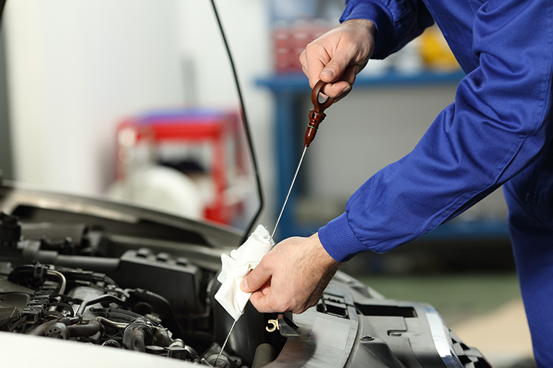 Checking Mazda engine oil level with a dipstick