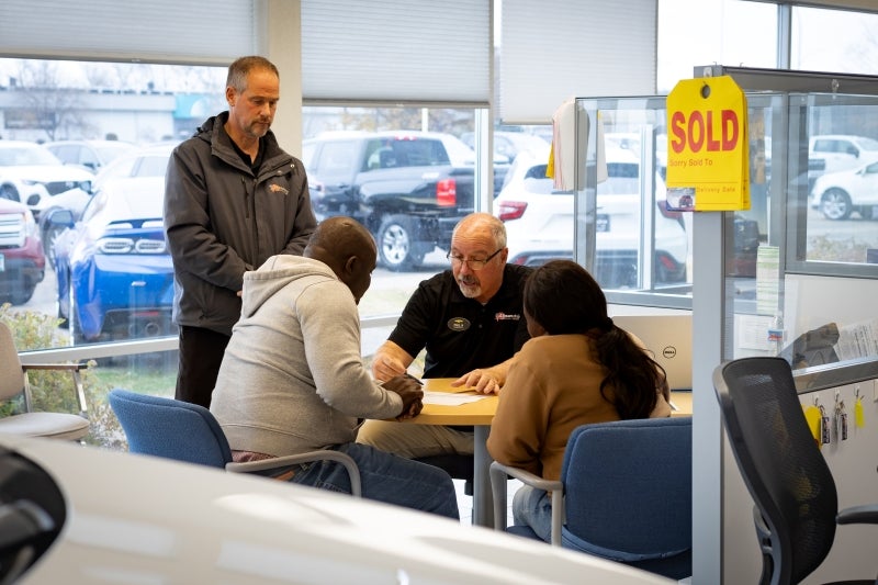 Shaking hands after a vehicle purchase at Alexandria Mazda